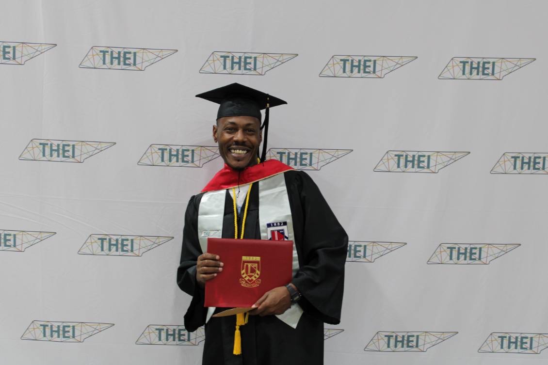 Almeer Nance, founder of The Crown Path Initiative, in cap and gown